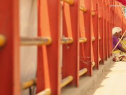 Beggar sitting on a bridge, Ganges River, Haridwar, Uttarakhand, India Stock Footage