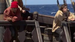 Christopher Columbus walks behind two sailors on the deck of their 15th century sailing ship. Stock Footage
