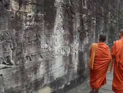 Cambodian monks walking at Bayon gallery Angkor Thom Stock Footage