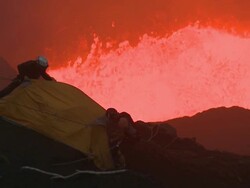 Climbers erect a tent dangerously close to erupting lava, Marum Volcano, Ambrym Island, Vanuatu Stock Footage