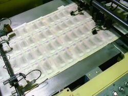 CU, HA, Sheets of American five dollar bills moving fast on conveyor, Washington DC, USA Stock Footage