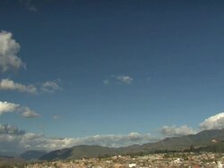 "Pan down from blue sky with wispy clouds to rooftops and Cathedral Church of Chachapoyas [LA IGLESIA CATEDRAL DE CHACHAPOYAS], Plaza De La Armas, Chachapoyas, Peru [PerÃƒÂº]" Stock Footage