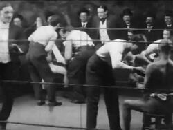 B/W 1906 boxers Chester Leon + George Dion entering ring / get prepped + start boxing / newsreel Stock Footage