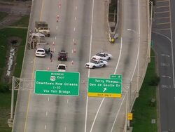 Sept. 12, 2005 aerial road block on Route 90 to downtown New Orleans / tracking shot police car driving off Stock Footage