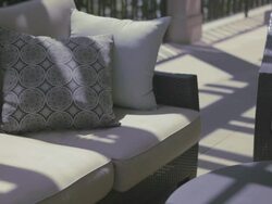 Patterns of light shift across outdoor furniture on veranda. Stock Footage