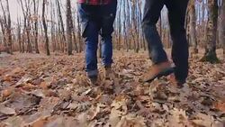 Couple having fun in forest, walking and fooling around Stock Footage