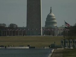 Medium Long Shot static - American flags wave at the National World War II Monument and the Washington Monument near the United States Capitol. / Washington, D.C., USA Stock Footage