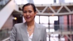Portrait of smiling businesswoman in atrium Stock Footage