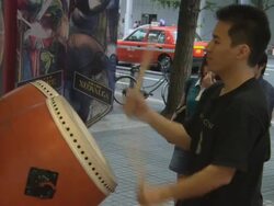 MS Young drummer entertaining onlookers on crowded sidewalk / Tokyo, Kanto, Japan Stock Footage