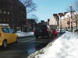 MS Shot of cars running on city street with snow covered sides of street / Boston, Massachusetts, United States Stock Footage
