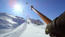 POV riding the surface ski lift up the sunny slope Stock Footage