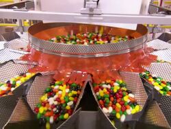 Medium static - Jellybeans pour into multiple chutes in a jelly bean factory /  Utah, United States Stock Footage