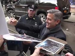 George Clooney (The Monuments Men) signs for fans outside of the Late Show with David Letterman Stock Footage