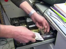 Scottish money being put in till News Clip