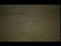 Rain on brown flowing water Stock Footage