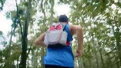 TS Man running across forest Stock Footage