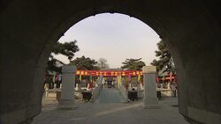 A stone arch frames the courtyard of the Bai Yun Guan temple in Beijing. Stock Footage