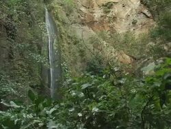 MS, Nicaragua, Waterfall along cliff face in jungle Stock Footage