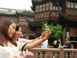 Young women looking at Chinese folk craft goods Stock Footage