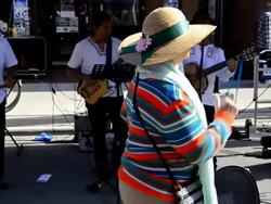 Senior women dancing in street during Dundas West Festival Stock Footage