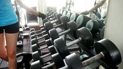 Young Woman Working With Weights In Gym Stock Footage