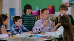 Teacher helps students assemble molecule model Stock Footage