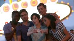 Group of friends take smartphone photos under classic Welcome To Las Vegas sign Stock Footage