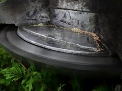 Camera pulls back slightly on close up of saw of feller buncher. Stock Footage