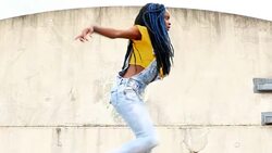 MS LA TU ZO PAN Female dancer dancing of rooftop of building Stock Footage