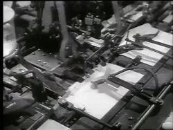 B/W 1944 close up machine putting War Bonds into envelopes / World War II / newsreel Stock Footage