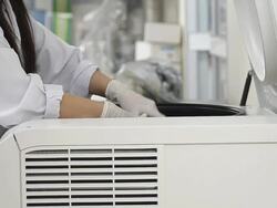 Scientists loading sample vials into centrifuge. Stock Footage