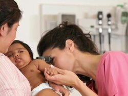 "hispanic medical worker checking the ears of a hispanic infant patient/Richmond,Virginia, USA " Stock Footage