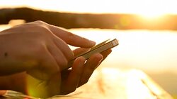 HD:Touching smartphone at sunset time Stock Footage