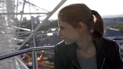 Young Woman Riding the Ferris Wheel Stock Footage