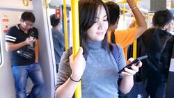 Woman use social media for communication in the sky train Stock Footage