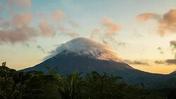 T/L Clouds forming over Arenal volcano at sunset Stock Footage