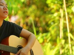 Young woman with accoustic guitar Stock Footage