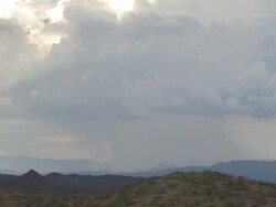 very heavy rain shower over distant mountains. Sonoran Desert near Tucson Arizona, USA Stock Footage