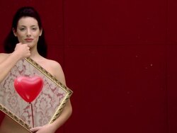 Nude woman holding a mirror with a reflection of a heart shaped balloon Stock Footage