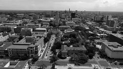 Aerial Over University of Texas Campus UT Clock Tower Austin Texas Skyline black and white Stock Footage
