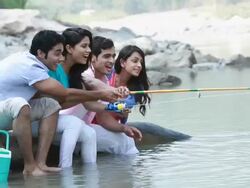 Group of friends fishing at riverbank Stock Footage