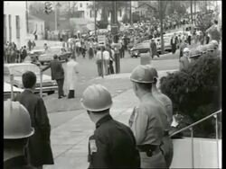 B/W 1960's wide shot of civil rights march on city street / Montgomery, Alabama / SOUND Stock Footage
