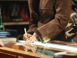 woman signing a receipt and carrying a shopping bag Stock Footage