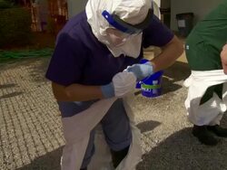 Workers remove gear after Ebola training Stock Footage