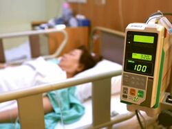 Focus in: Hospital Patient with Saline Solution Volumetric Infusion Pump Stock Footage