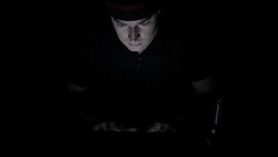 High angle view of man working on computer in the dark Stock Footage