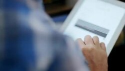 Modern clothing store worker manages inventory on tablet Stock Footage