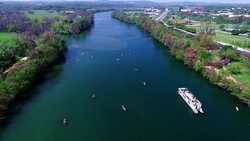 Middle of Lake Aerial View Austin Texas Colorado River Fun Spring water activities with kayakers and Party Boat during SXSW Spring Break 2016 Stock Footage
