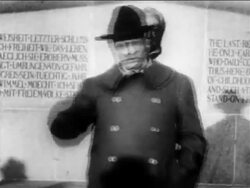 B/W 1900s Theodore Roosevelt in overcoat + hat giving speech in front of monument / newsreel Stock Footage