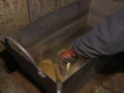 Newly cast gold ingots being put in box News Clip